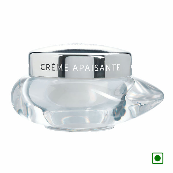 Soothing cream jar close-up, clear glass base with black top labeled “CREME APaisante”